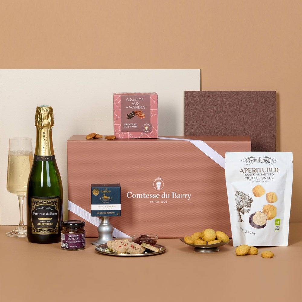 The Signature Edit food hamper with whole duck foie gras, Champagne Brut Comtesse du Barry, fig chutney, truffle biscuits, orangettes, mini financiers and chocolate-coated almonds.
